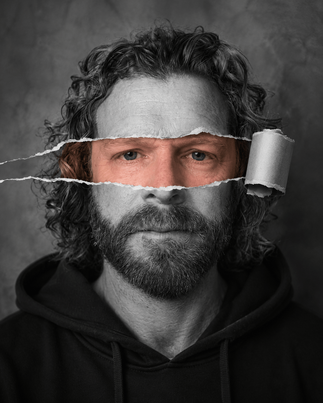 Stylized portrait of J.S. Ainslie with a torn-paper effect across the eyes